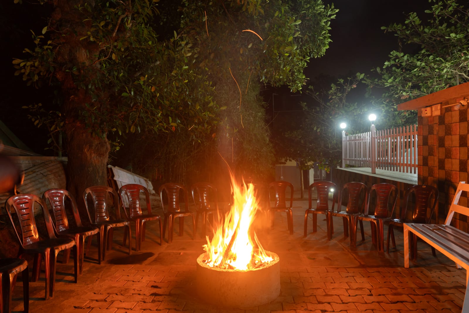 Circle of friends around a campfire at dandeli homestay resort
